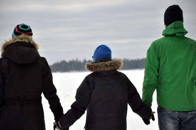 Vanhemmat ja lapsi järvellä