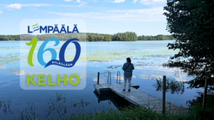 Järvimaisema Kelhossa Lempäälässä, laituri ja järvelle katsova henkilö sekä Lempäälä 160 vuotta -logo.